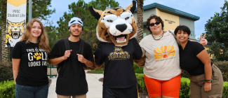 Students posing with PHSC mascot, Boomer